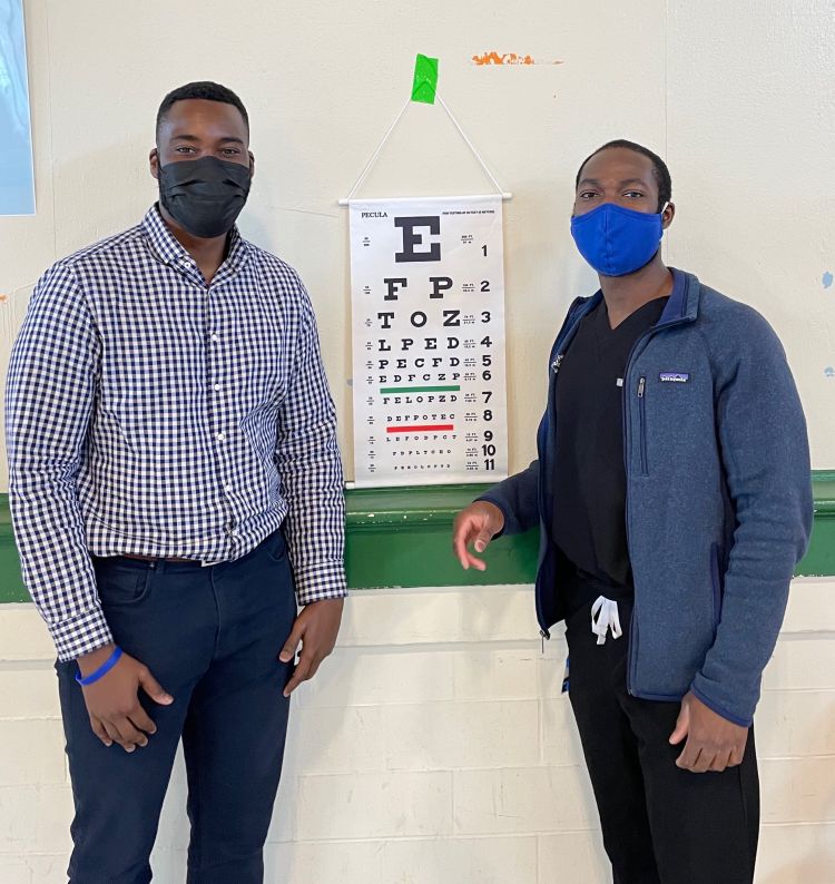 two students from Duke University School of Medicine conduct free vision screenings at local school
