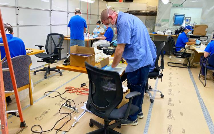 Employees with Duke Health Engineering & Operations assemble protective face shields. Photo courtesy of Duke Health Engineering & Operations.l