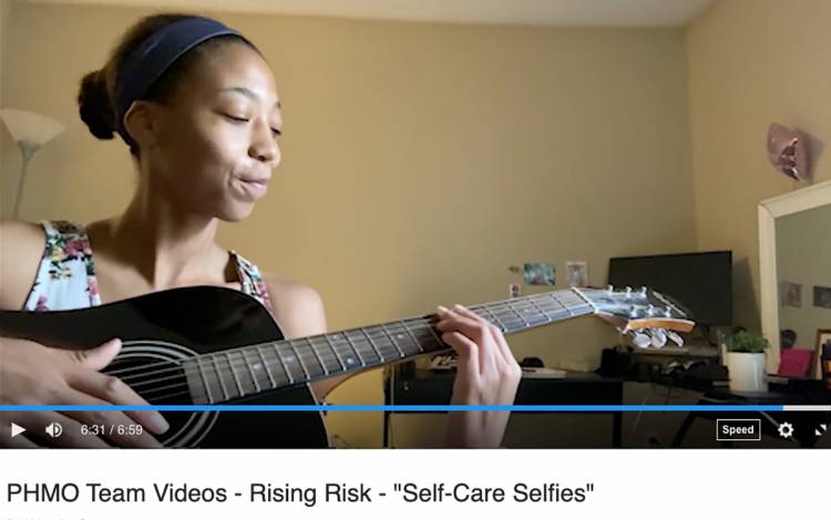 Jamilah Watson, with the Duke Population Health Management Office, plays the guitar in an e-newsletter video. 