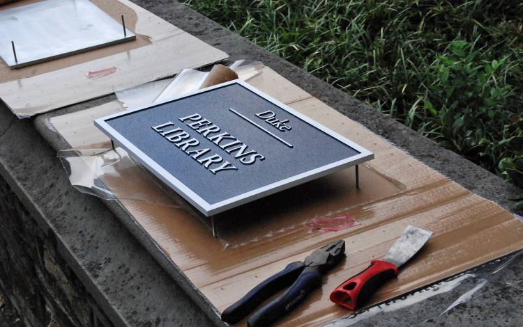 The plaque for Perkins library was removed from its box, assembled and later installed in front of the entrance to the building. 
