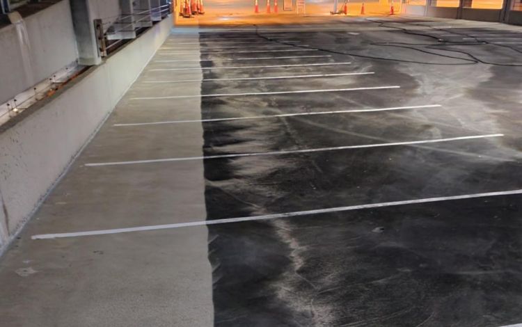 A noticeable difference on the cleaned pavement to the left is part of the results of a power washing project at some of Duke's largest parking decks this summer. Photo courtesy of Duke Parking & Transportation.