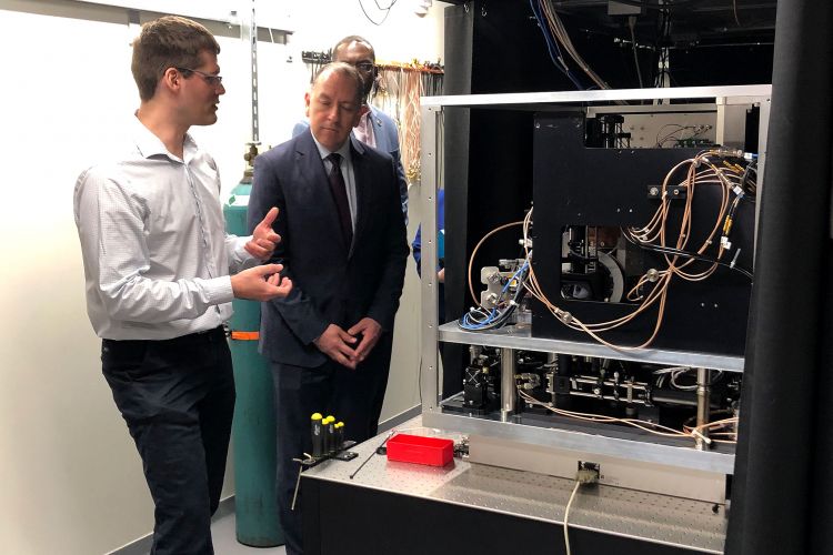 Duke physics professor Marko Cetina (left), speaks with Gabriel Camarillo, under secretary of the Army, about a powerful quantum computer, a project funded by the U.S. government. (Photo by Duke University Communications)