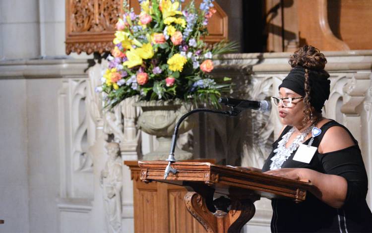 Theresa Bayless, a Duke University Hospital chaplain, reads They are Gone, a poem by David Harkins. Photo by Stephen Schramm.