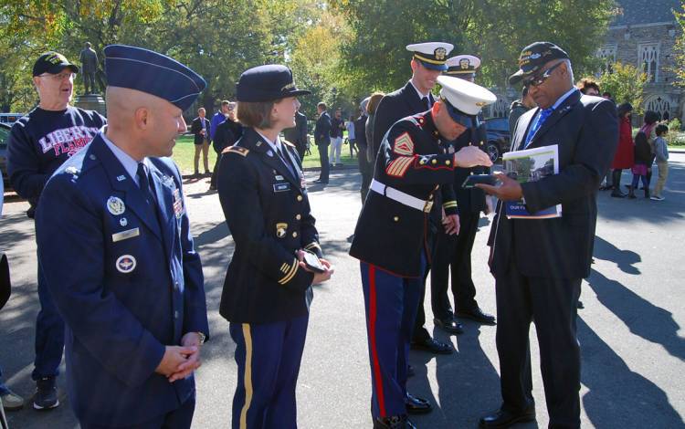 Phail Wynn meets with members of the Armed Services at the 2017 Duke Veterans' Day service.