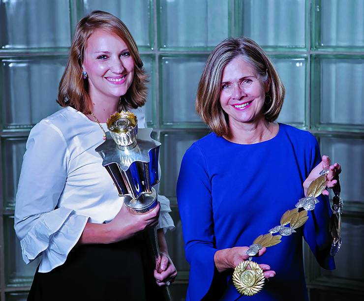 Kaitlin Briggs, left, and Terry Chambliss, right, of the Office of Special Events and University Ceremonies hold the Duke University mace and chain of office.