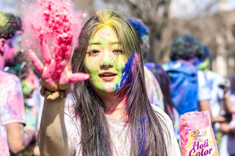 Tossing colors during the Holi celebration Saturday on West Campus. Photos by Jacob Whatley