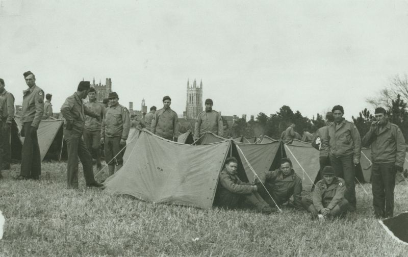 Members of the 65th General Hospital with tents and camping gear on the Duke University campus.