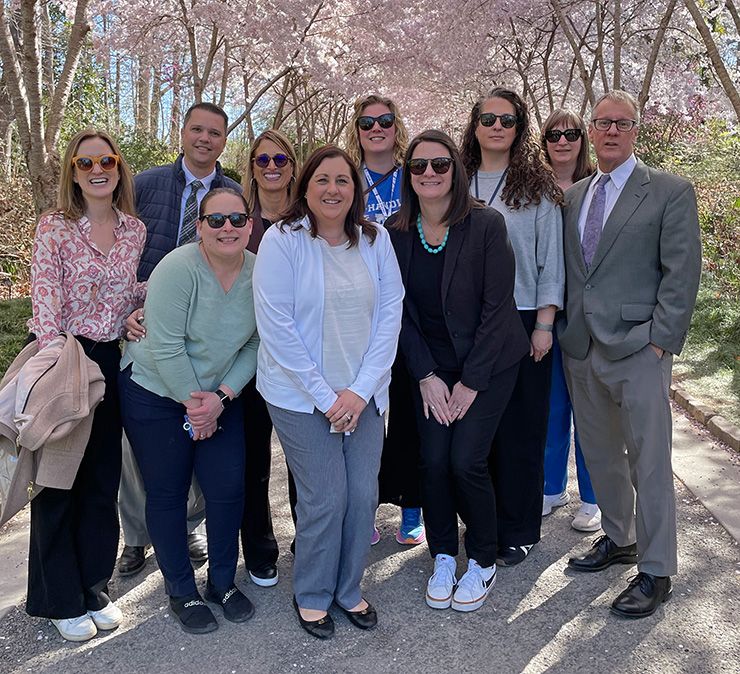 Brooke Lafko, third from left in green, poses with Duke Cancer Institute colleagues at Sarah P. Duke Gardens.