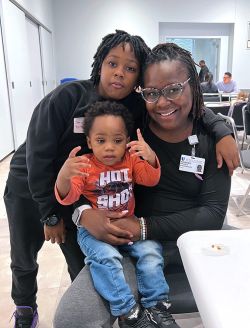 Amneste Bynum-Brake poses with her two young children at Duke Moms event.