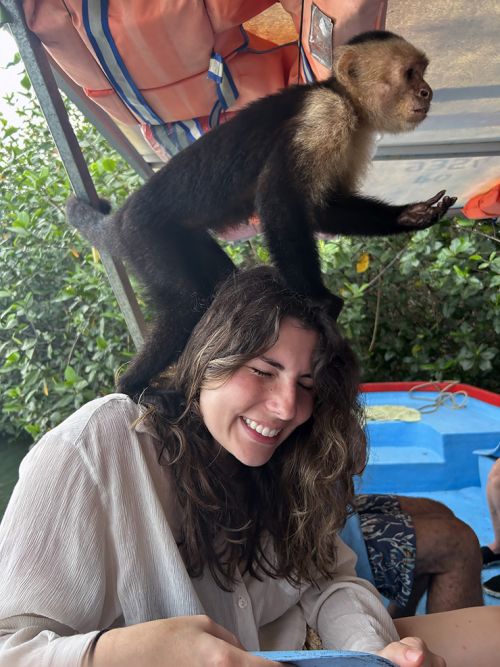 A monkey on a woman.
