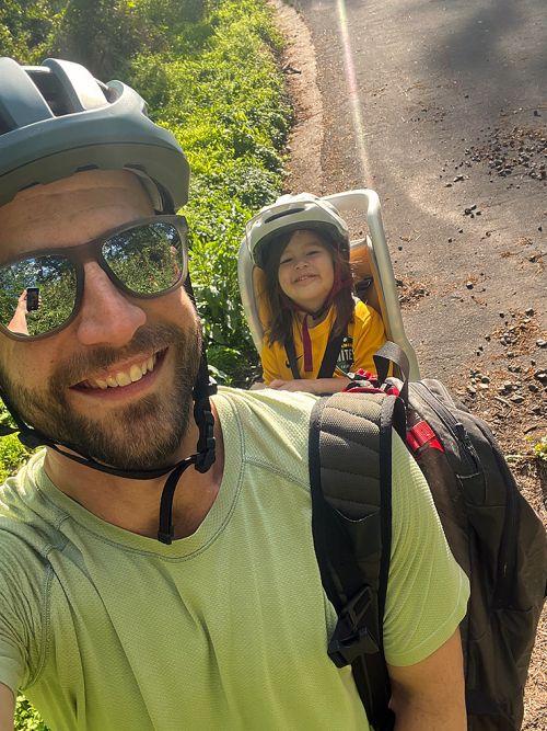 Mike Yarrington and 3-year-old daughter Quinn break during a bike ride