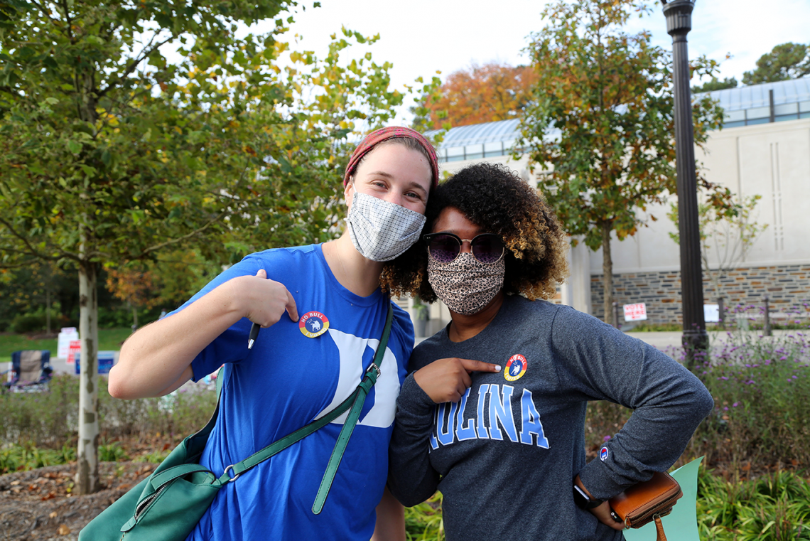 Early voting at Duke can even bring rivals together. Meredith Rawls, a Duke Divinity School student, poses after voting with UNC social work student Nikki Moore.