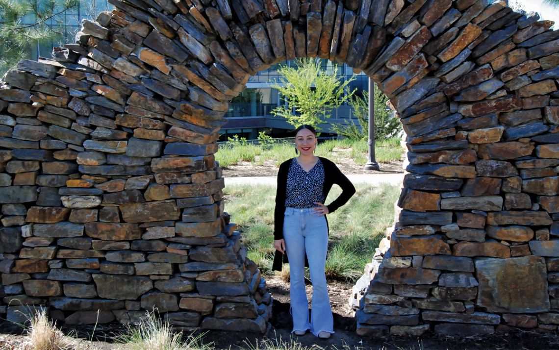 Brittany Hunt stands in front of a stone archway located in front of the Nicholas School of the Environment. Hunt is one of 324 Duke faculty and staff who identify as American Indian or Alaskan natives. Photo by Jack Frederick.