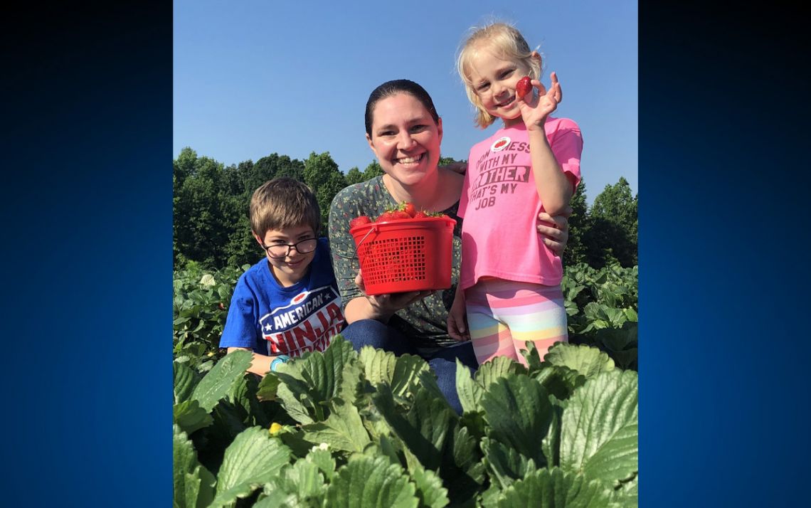 Katelynne Durrant and her family picking strawberries.
