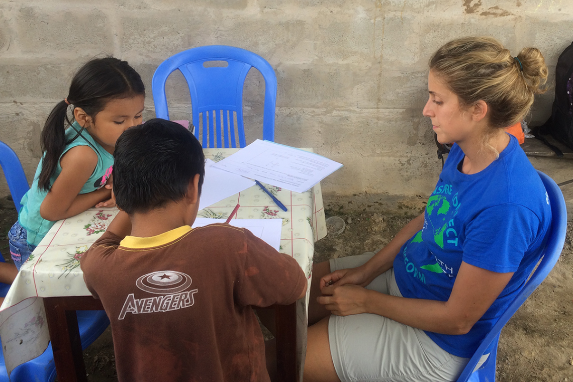Duke researcher Helena Frischtak, (right front) administers psycholocal assements with a pair of Peruvian children during a study of mercury contamination near small-scale gold mining. (Bill Pan, Duke)