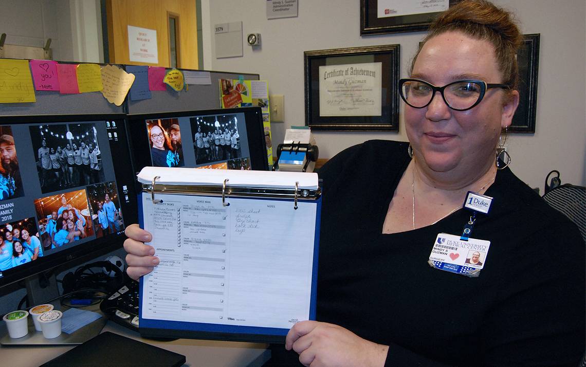 Mindy Guzman, program coordinator with Duke Surgery, shows the list she uses to plan each work day. Photo by Stephen Schramm.