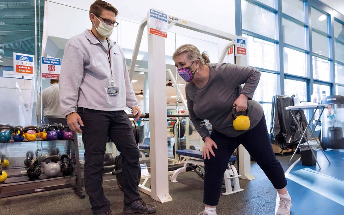 A personal trainer works with one of the members of the Duke Health and Fitness Center. Photo courtesy of the Duke Health and Fitness Center.