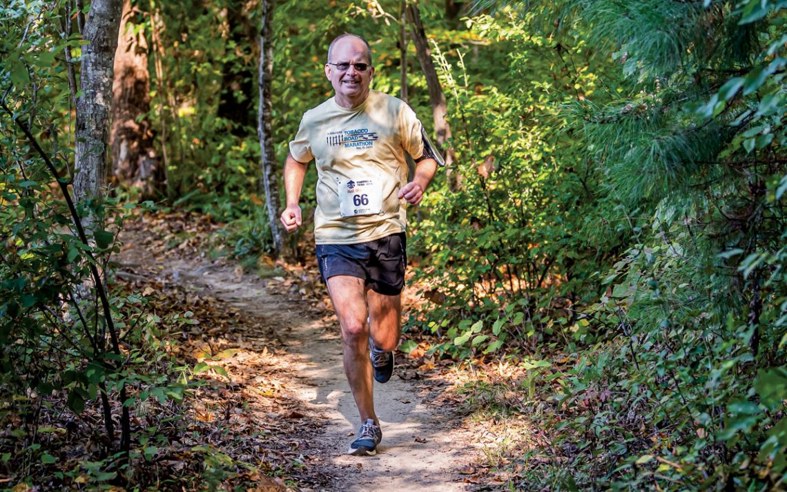 Mark Walters, running through the trees during the Rootrock Trail Run, will participate in the Boston Marathon next week. Photo courtesy of Mark Walters.  