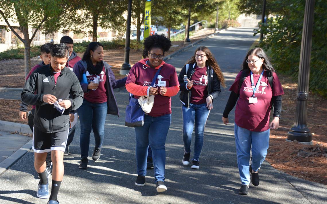 Katryna Robinson, center, with Duke University Libraries, guides Durham Public School students around campus during the 2019 