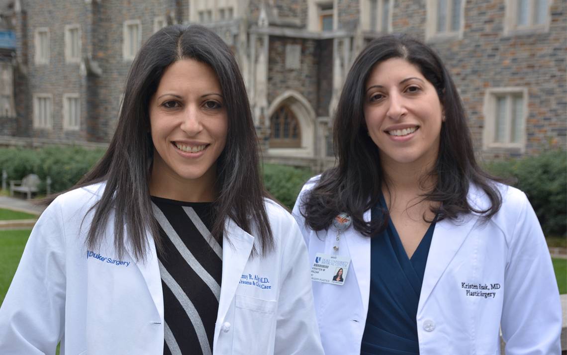Amy Alger, left, and Kristen Rezak, right, are identical twins and surgeons for Duke Health. Photo by Jonathan Black.