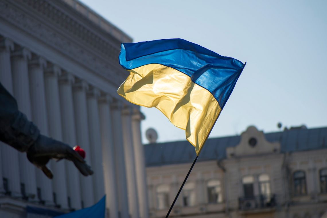A Ukrainian flag waving in front of a building. 