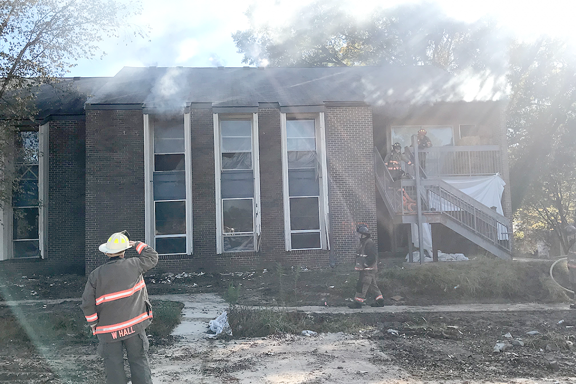 Durham firefighters enter a burning Central Campus apartment during training exercises. Photo by Hector 