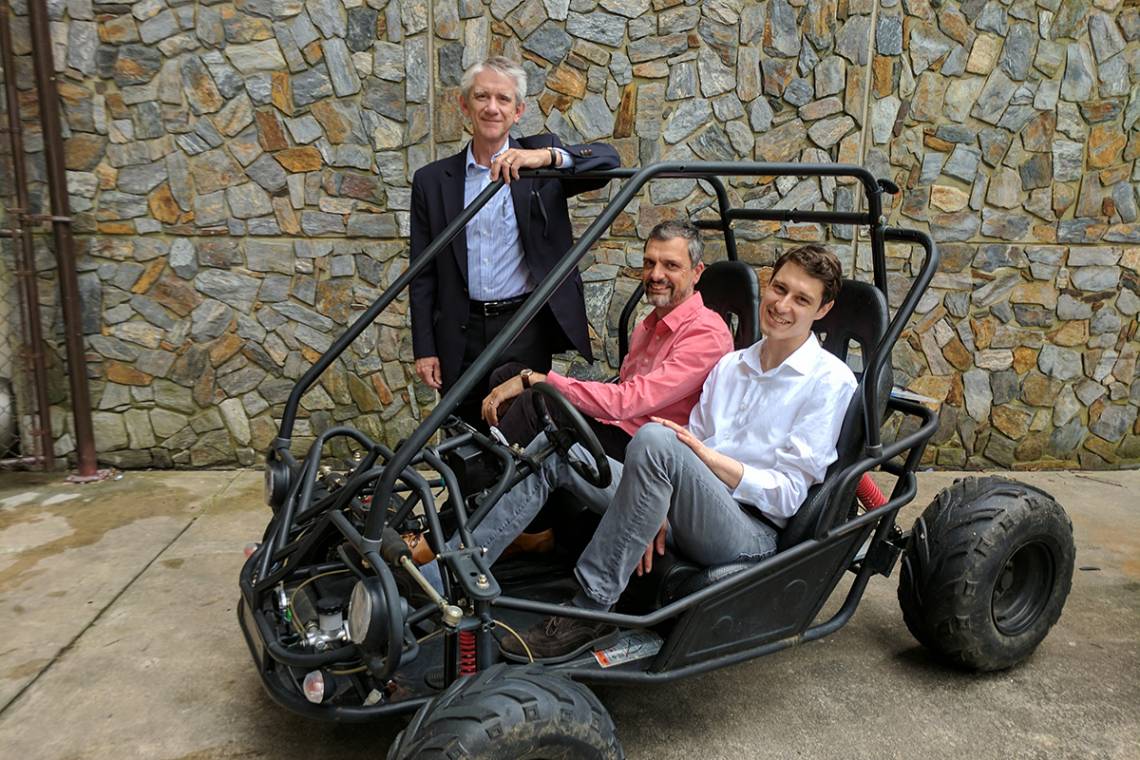 Mechanical engineering professor Josiah Knight, standing, with neuroscientists  Angel Peterchev and Stefan Goetz on right. The team’s new battery and power conversion system will be the heart of this student-built vehicle for the Shell Eco-Marathon.