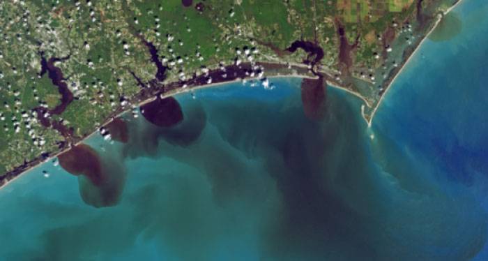 An NASA Landsat image showing river basins dumping polluted waters into the Atlantic.