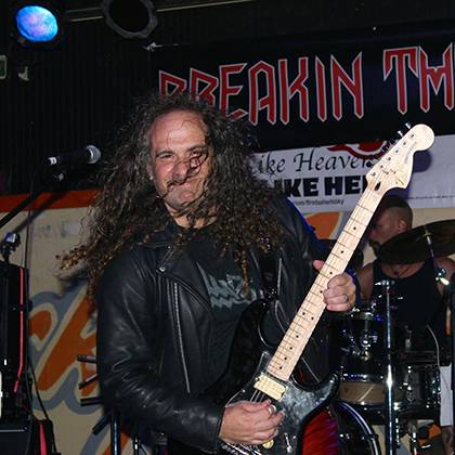 Stephen Toback rocks out on his bass guitar performing with his Judas Priest cover band, Breakin the Law. Photo courtesy of Steve Toback.