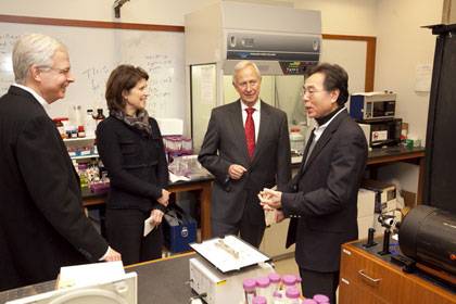 Tuan Vo-Dinh, right, is a participant in the Duke-Coulter Translational Partnership. Visiting his lab are Duke President Richard Brodhead; Kimberly Jenkins, provost for innovation and entrepreneurship; and George Truskey, chairman of biomedical engineeri