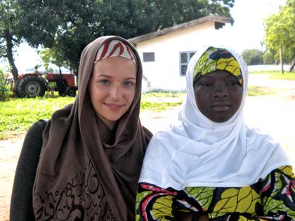 Anastasia Karklina (left) stands with a friend during her first trip to Ghana for study abroad in Fall 2012.