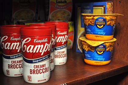 The Student Meal Exchange cupboard in the Duke School of Nursing offers soups, mac and cheese cups, granola bars and other items for students who need a meal. Photo by April Dudash