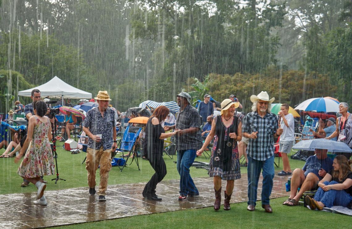 dancers in the rain at Terrance Simien and the Zydeco Experience