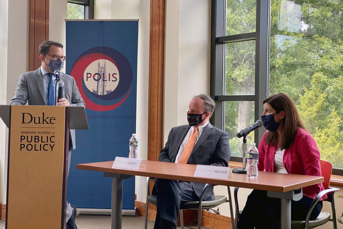 Caption: Asher Hildebrand of the Sanford School of Public Policy moderates a session with John Hood, president of the John William Pope Foundation, and Caroline Mackie, a partner with Poyner Spruill. Photo by Amanda Solliday