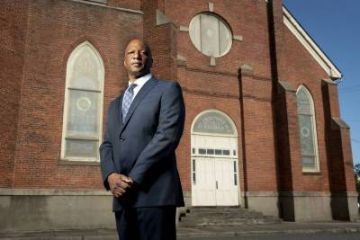 Quinton Dixie in front of Durham's historic St. Joseph's AME Church building.