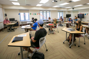 Professor Michael Newcity leads a FOCUS class in a room where the students have been set apart.