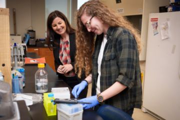 Duke Professor of Psychology and Neuroscience Staci Bilbo and postdoc Lauren Green spend time in the lab observing microglia cells. Photo by John West / Trinity Communications