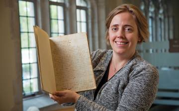 Duke University Archivist Valerie Gillispie holds the constitution of the Union Institute Society. Written in 1839, it is the founding document of the school that later grew into Duke University.