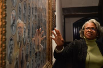 Wilmington historian Cynthia Brown gestures to an artwork at St. Stephen AME Church. (Huiyin Zhou)