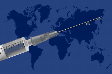An image of a syringe in front of a world map.