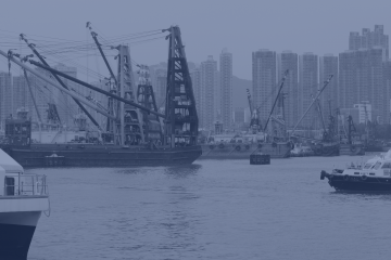 A picture of the Hong Kong harbor with cargo ships.