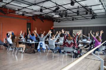 Faculty writers get their bodies moving during the session.