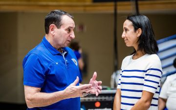 Duke basketball coach Mike Krzyzewski, left, and Nina King talk on the sidelines at Cameron Indoor Stadium pre-COVID. Photo courtesy of Duke Athletics.