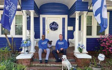 Maxie, left, and Mark Hipps-Figgs, right, sit on the porch of their Durham home, which showcases their Duke pride. Photo courtesy of Maxie and Mark Hipps-Figgs.