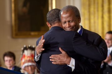 Sidney Poitier is hugged by President Barak Obama at the White House.
