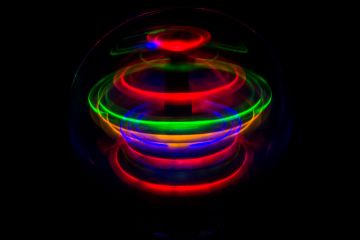 A colorful spinning top represents the concept of spin. (Colin via Wikimedia Commons)