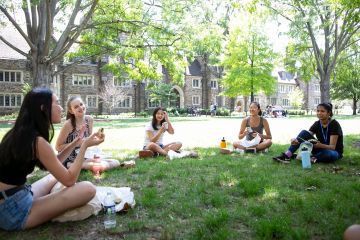 students on West Campus engaged in conversation while eating.