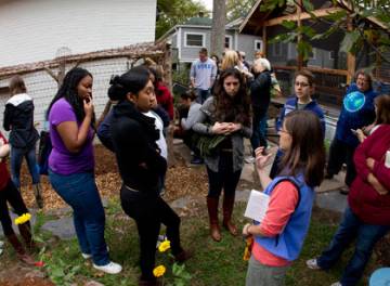 Durham resident Chris Crochetiere, foreground, talks to Duke students about what is involved in raising chickens in the city.  Photo by Jon Gardiner/Duke University Photography