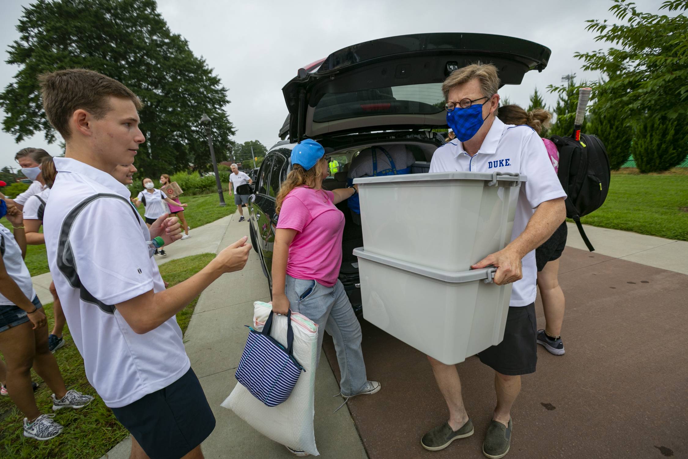 Duke University President Vincent Price, right, helps with move-in activities during move-in day on Duke’s East campus. 